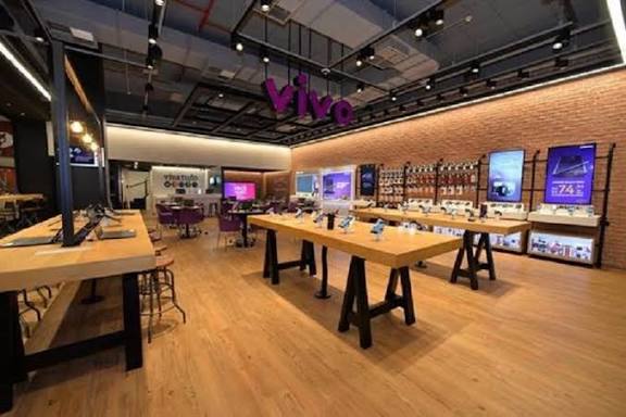 Ambiente de loja de tecnologia com mesas de exposição de dispositivos